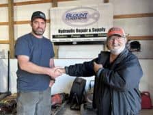 Our owner shaking hands with a customer