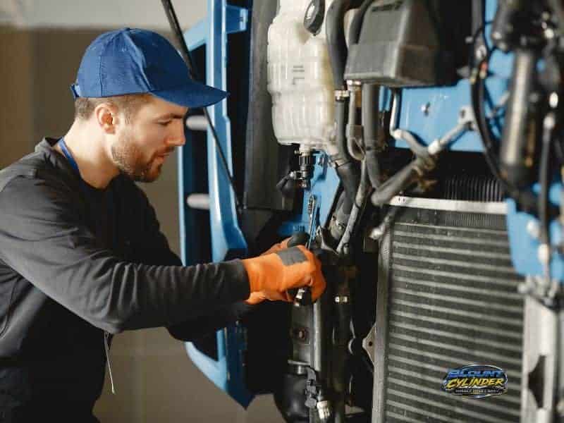 Need Assistance? Man working on industrial equipment in a workshop